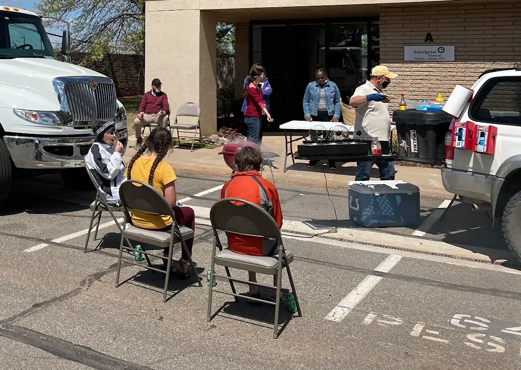 Residents waiting beside the staff table at a Shred-Away community shred day.